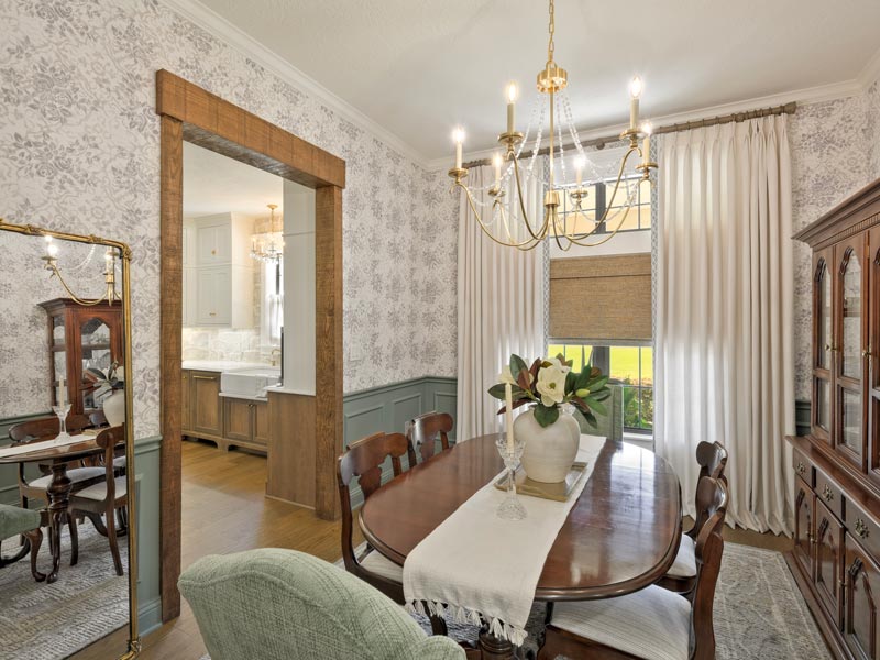 dining room with curtains and woven shades